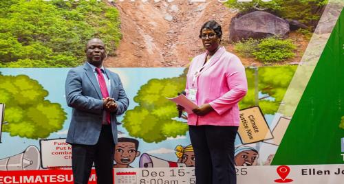 Hon. Anthony Kollie receives certificate from Loretta Pop-Kai