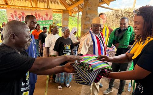 SIDA Gender program coordinator receives Liberian country clothes made by the women at the traditional art school