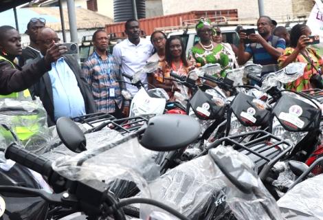 AAL country director and others inspecting the bikes