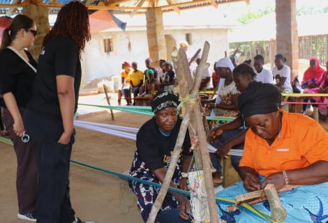 Dwede Tarpeh of the Swedish Embassy and Team mate look on carefully as the women make the Liberian Country clothes