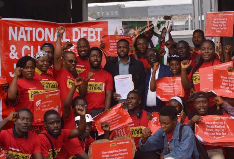 Representative Prince Tole and petitioners of the National Debt and Climate Campaign