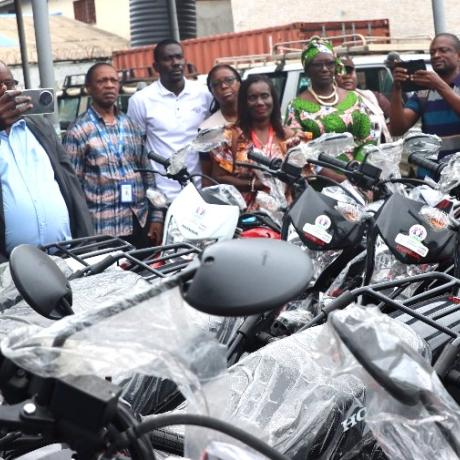 AAL country director and others inspecting the bikes