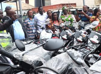 AAL country director and others inspecting the bikes