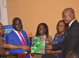 ActionAid Country Director, EPA director, and civil society leaers holding copy of the report as the launch it