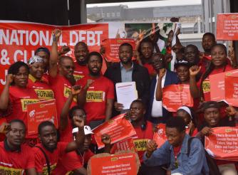 Representative Prince Tole and petitioners of the National Debt and Climate Campaign